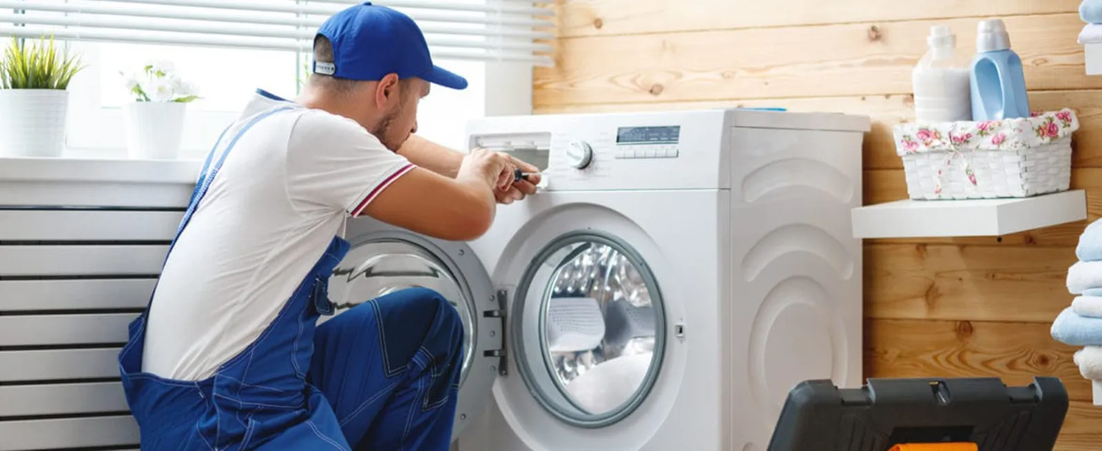 Technician repairing a front load washing machine